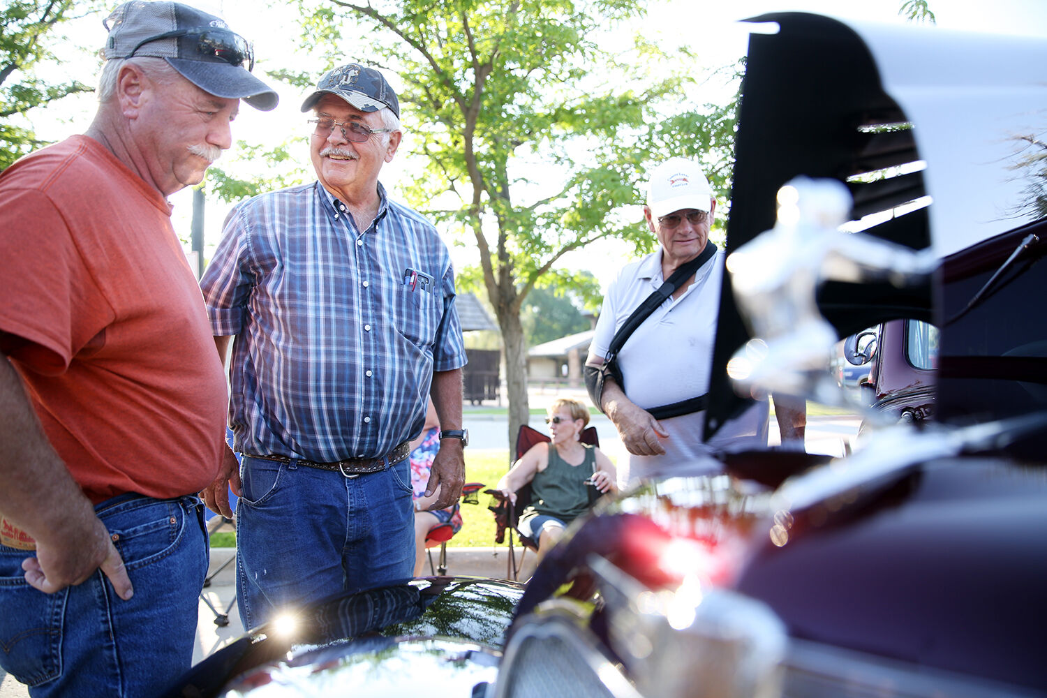 Greg Walker, Dan Wasserburger and Gary Garland look in at the engine of the ’35 Buick Sedan